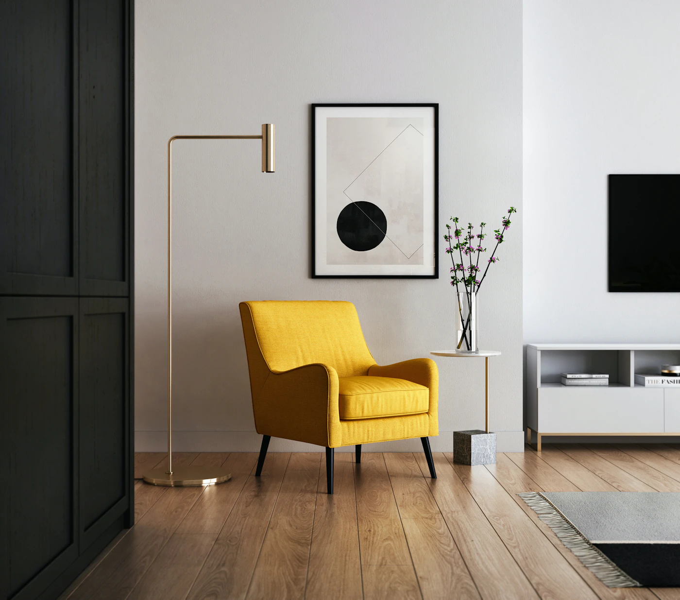 A yellow upholstered chair beside a floor lamp and framed artwork in a pale room.