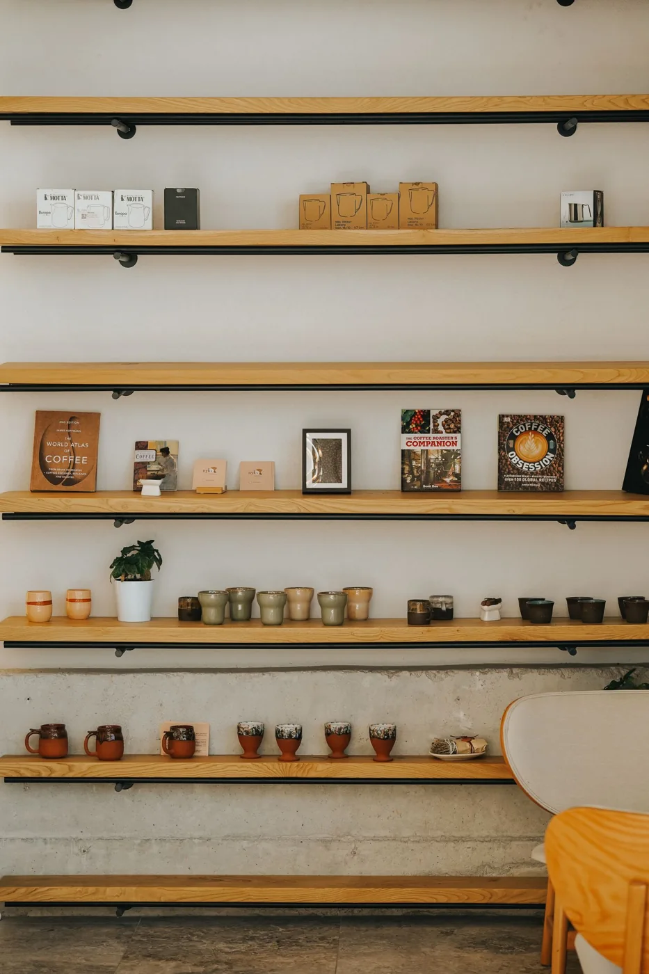 Long wooden wall shelves holding small decorative objects.