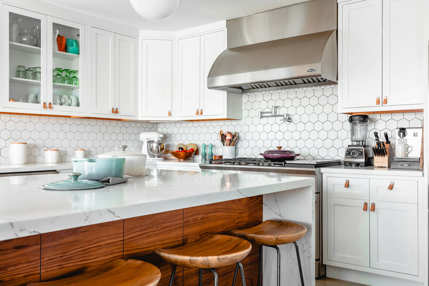 Bright kitchen with a tiled backsplash and wooden breakfast bar